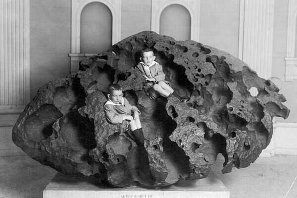 The Willamette Meteorite on Display: Two young boys sit on the largest meteorite found in the United States.